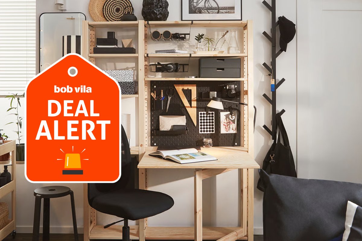 Ikea Skadis black pegboard hung behind a wood desk to organize a studio with a modern-but-natural design style