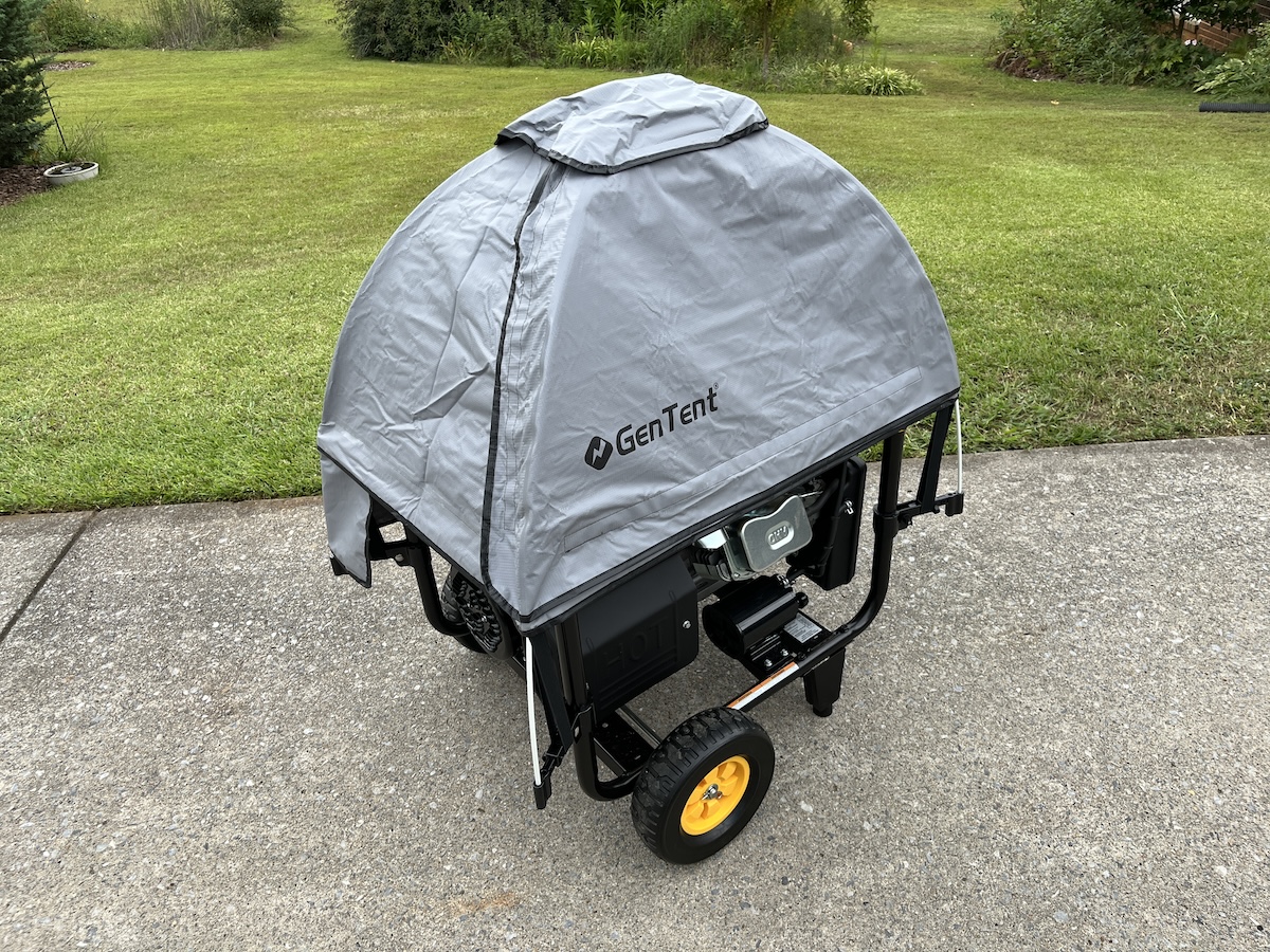 A grey GenTent cover placed over a portable generator to protect it from the outdoor elements. 