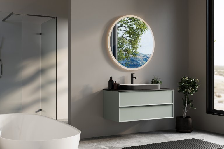 Minimalist bathroom with a round mirror, floating vanity, and natural greenery, offering a view of serene outdoor scenery.