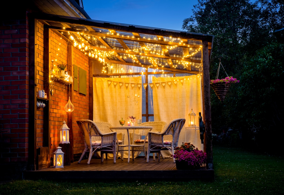 A small backyard patio with string lights.