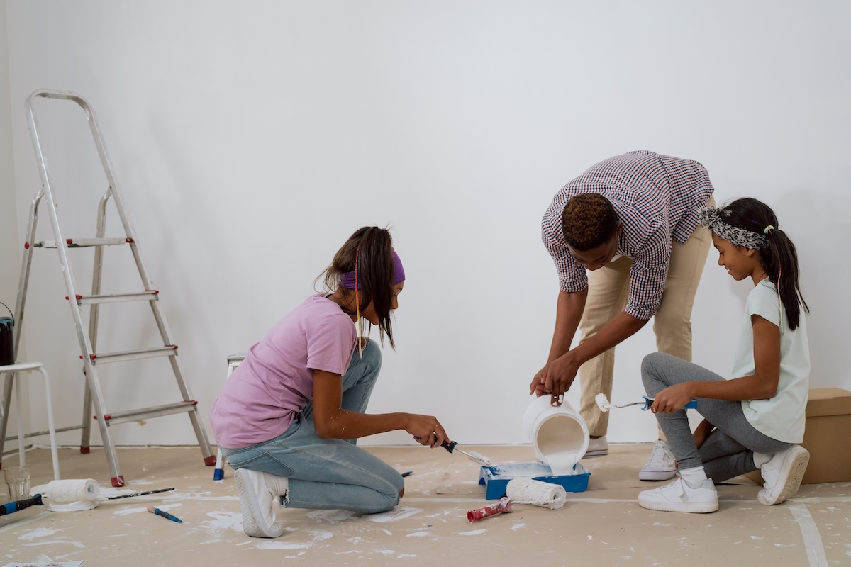 A family painting a room together.