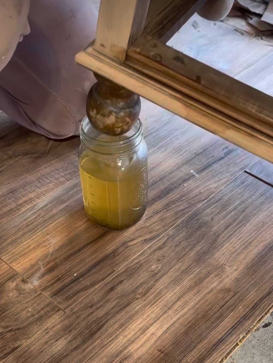 Dipping furniture feet in finish remover.