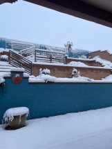 A blue block fence in a winter landscape.