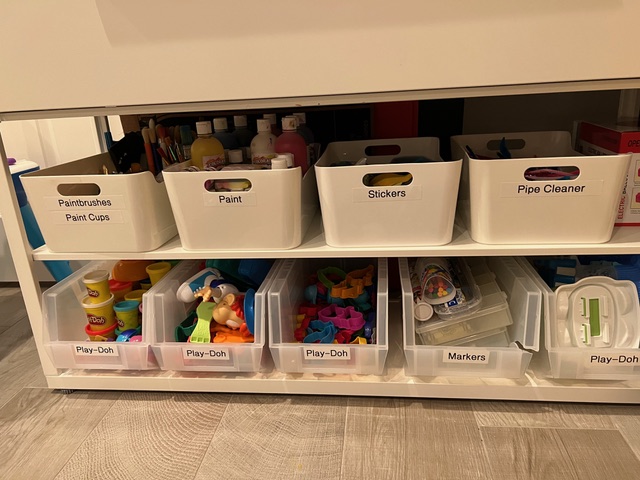 Easily accessible labeled bins filled with organized art supplies.
