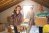 Friends unpacking boxes in attic