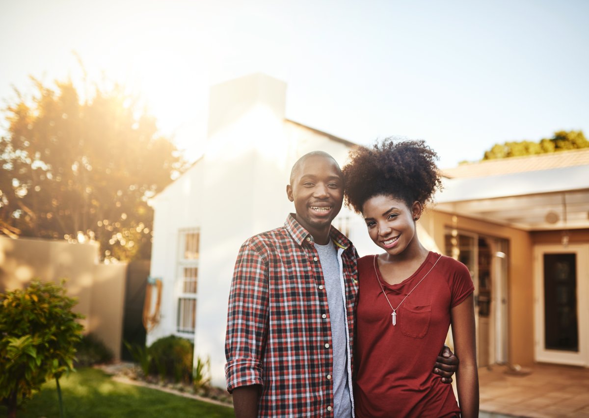 Proud first-time homeowners. Portrait of a young Black couple standing outside in front of their new house.