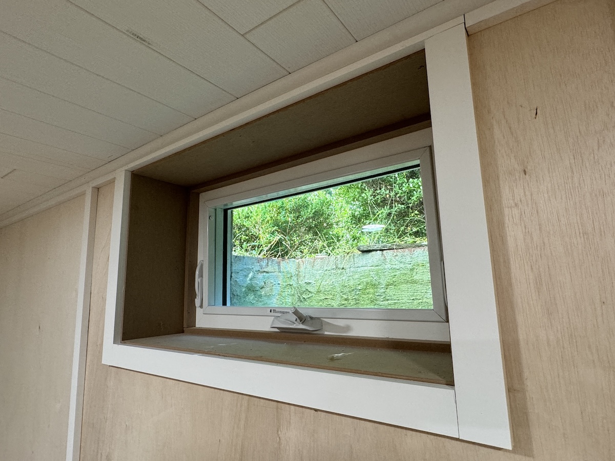 After photo of a trimmed basement window.