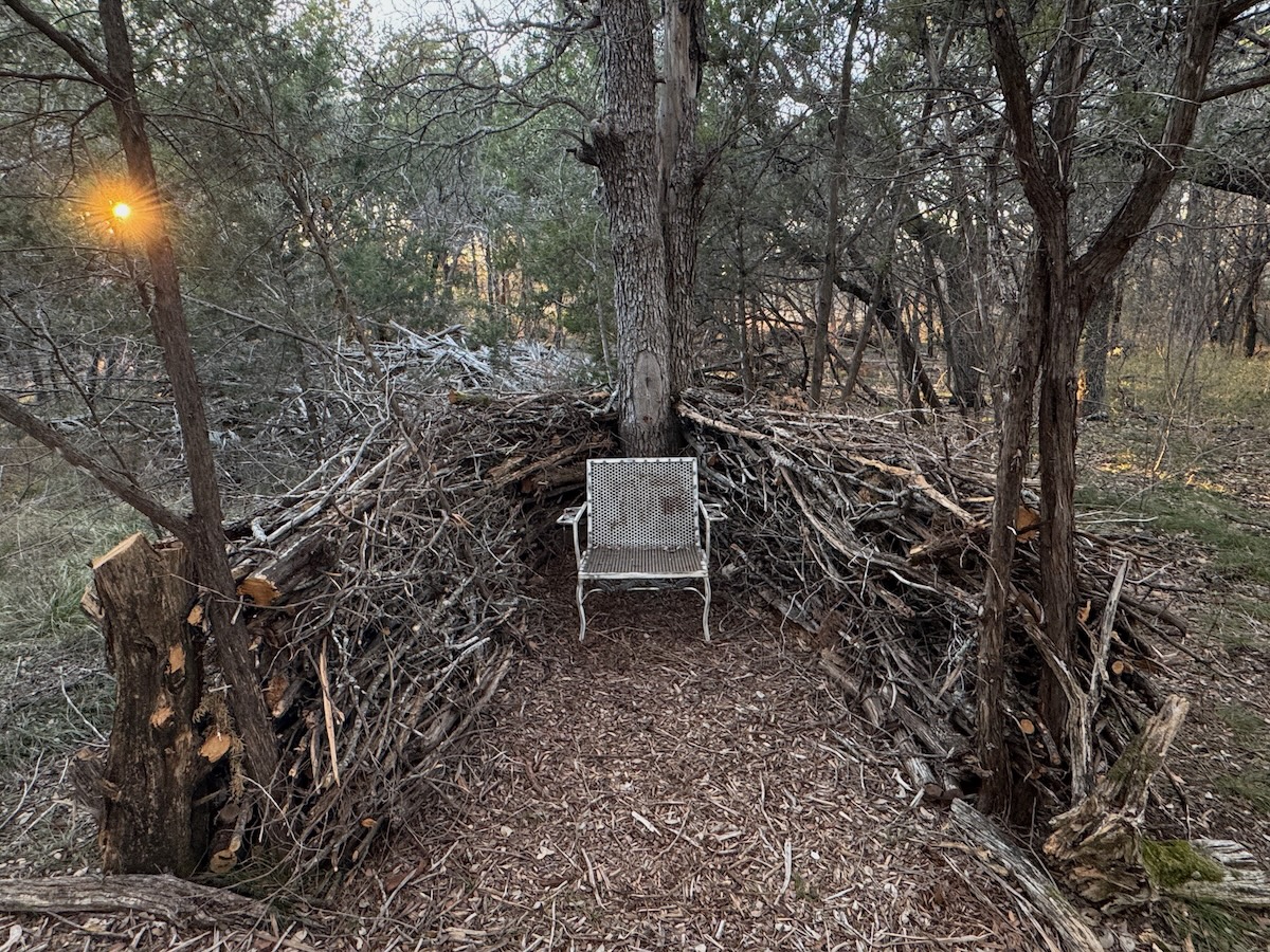 A meditation nook created in a backyard using DIY dead hedge fences.