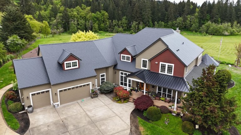 Mixed styles of metal roofing on a large single-family house.
