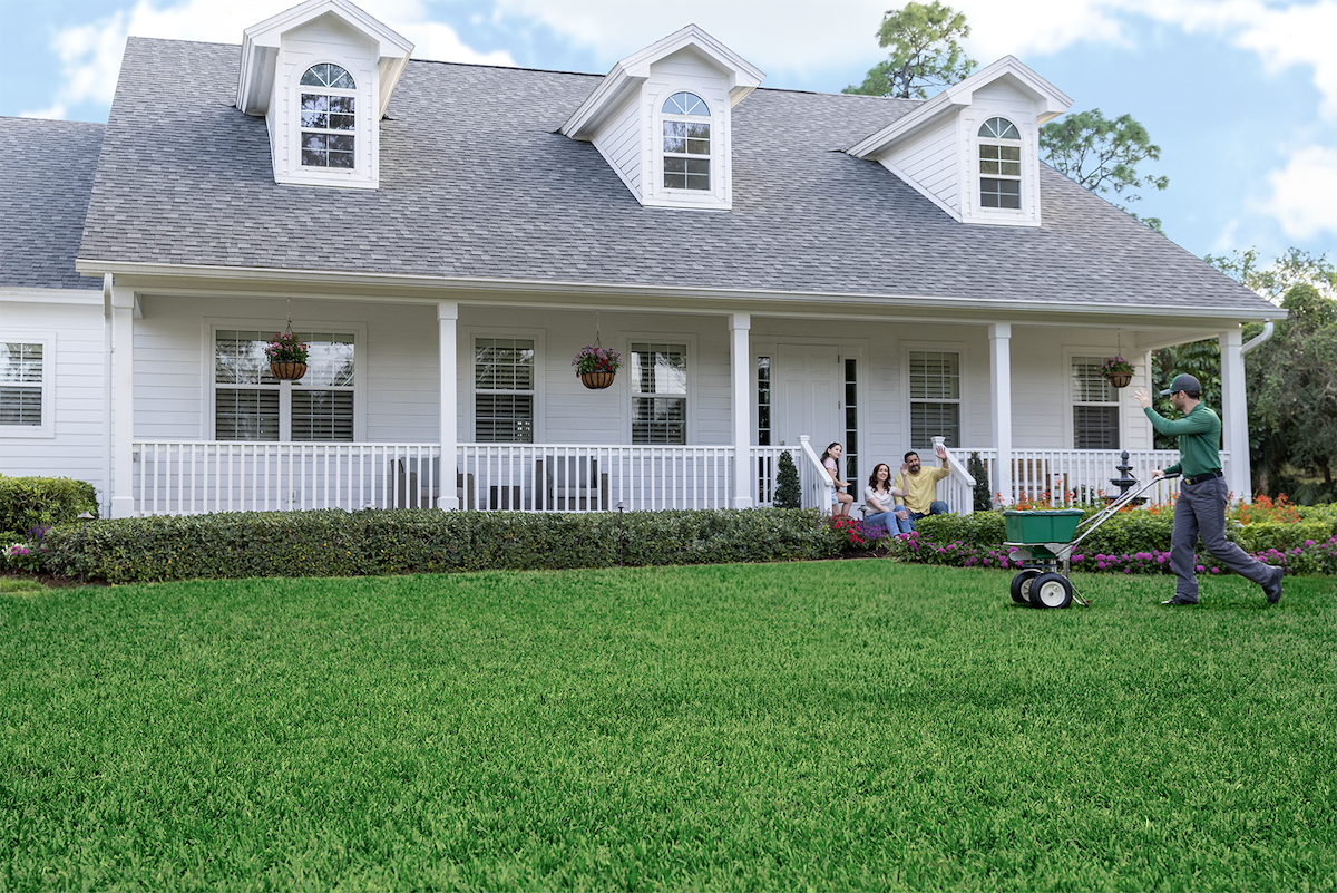 A TruGreen expert fertilizing a customers lawn.