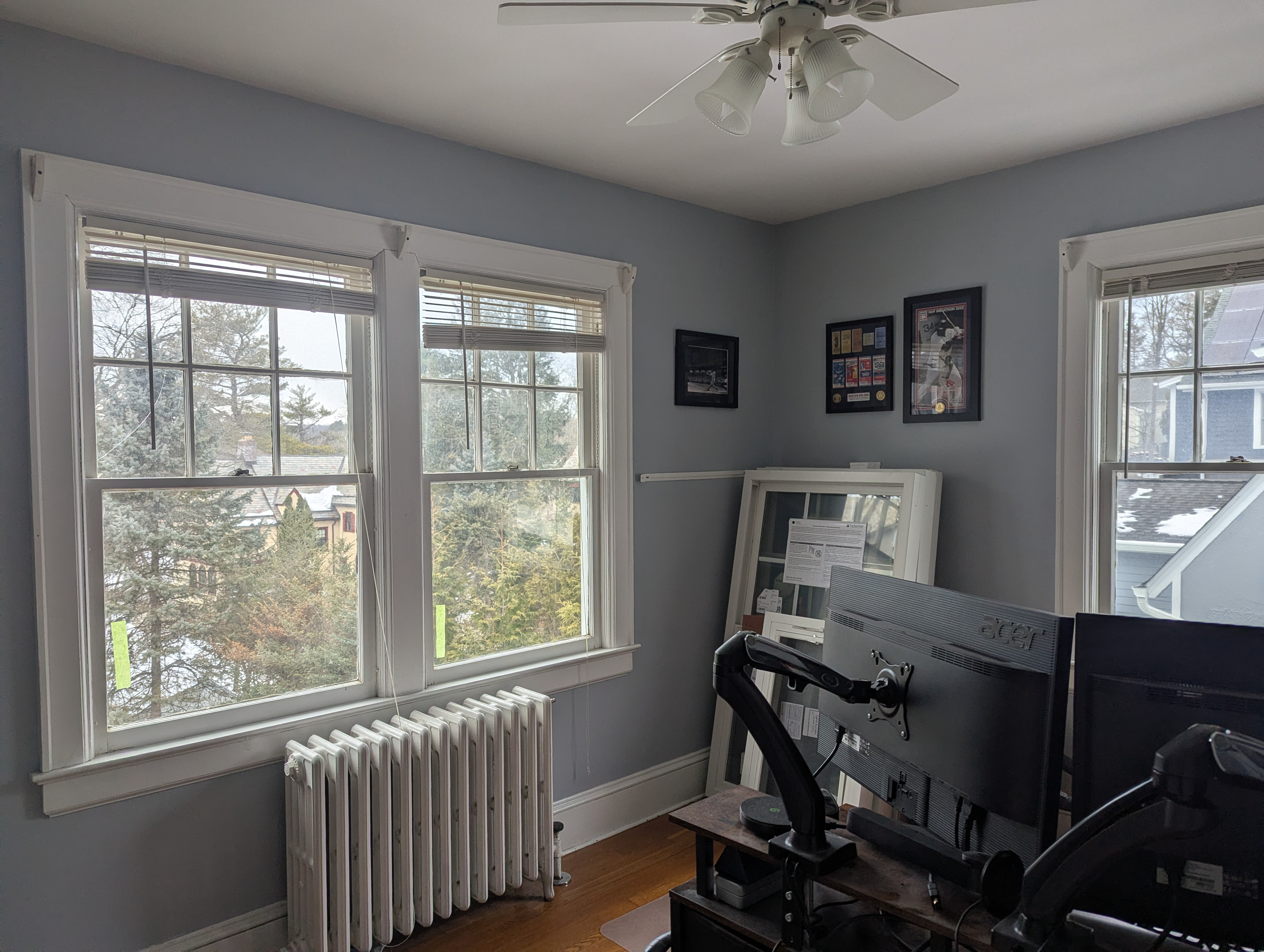 Original Windows in a Home Office with New Windows Leaning Against a Wall Before Installation