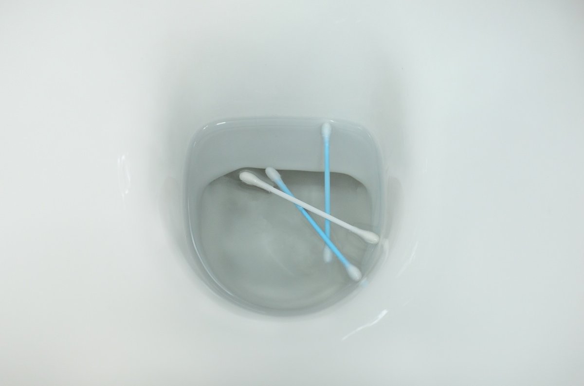 Cotton swabs thrown in a toilet.