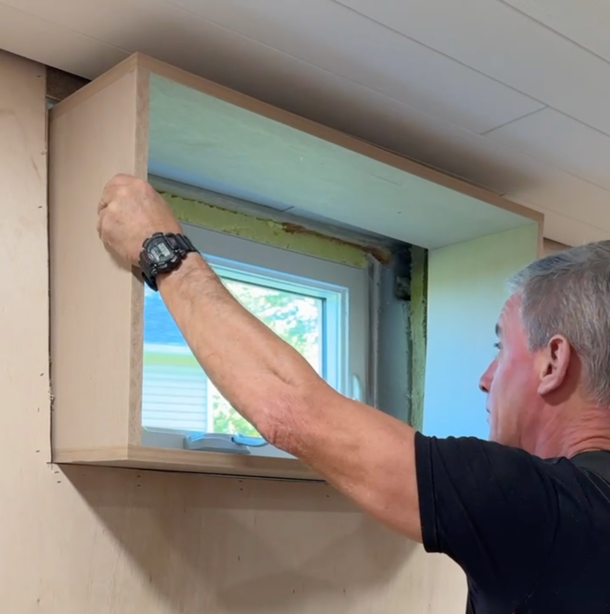Dry fitting a window box for trimming basement windows.