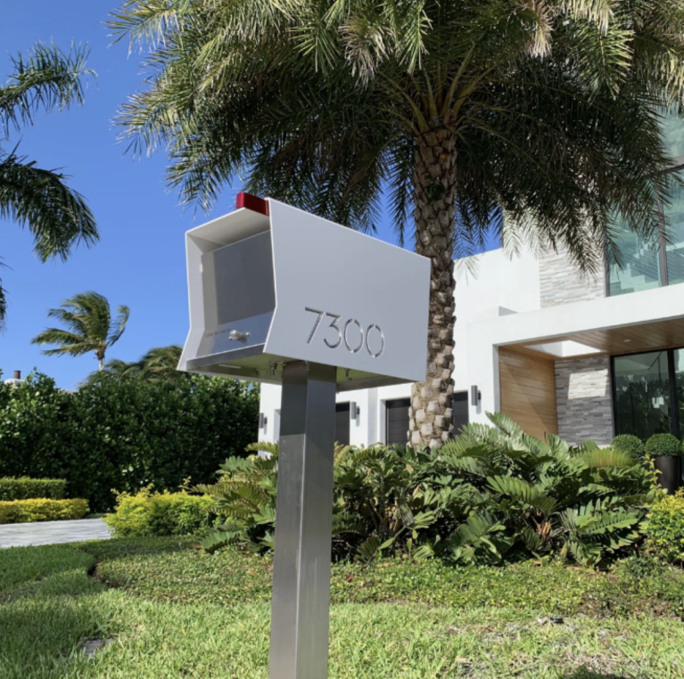 RetroBox Mailbox by TedStuff in front of a modern house and palm trees