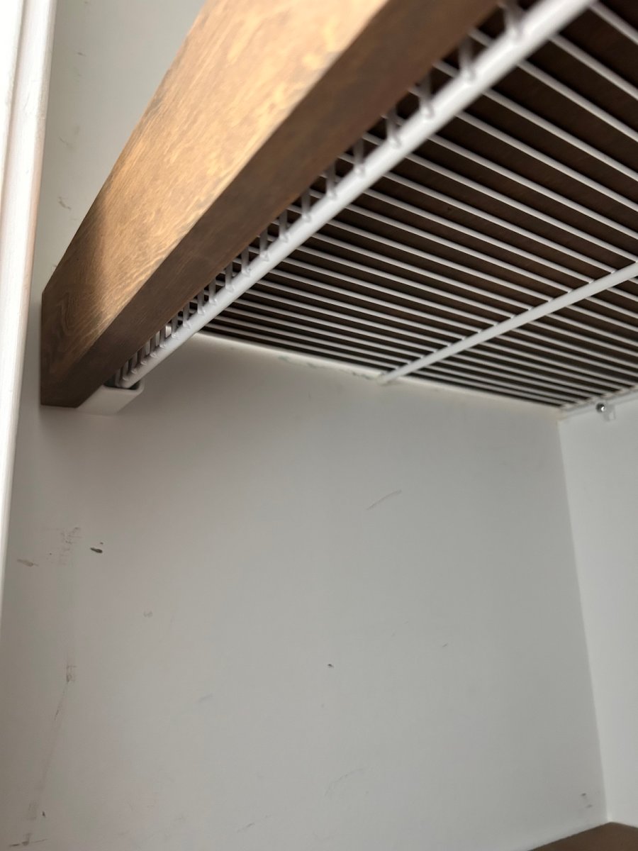 Closeup of under wire shelf showing how wood cover sits on top.