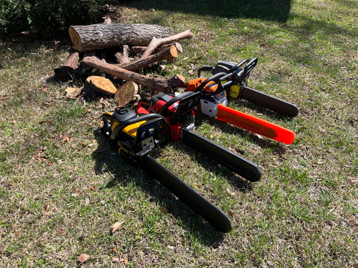 A group of the Best Gas Chainsaws next to a wood pile during testing 
