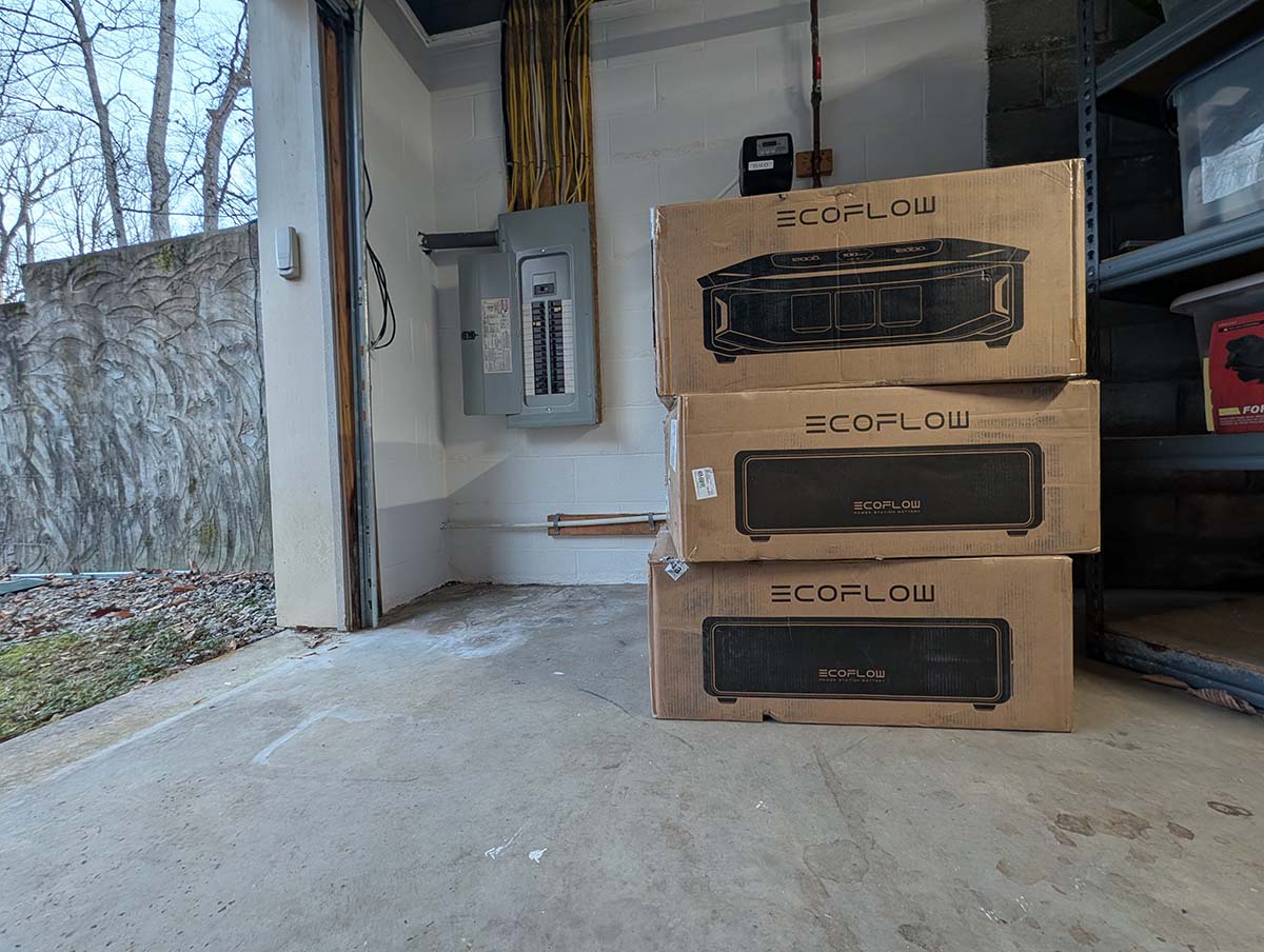 Three boxes of EcoFlow Delta Pro Ultra X components stacked in a garage before installation and testing