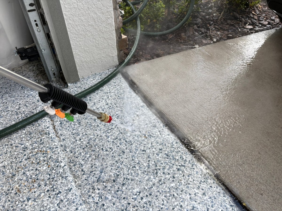 Giraffe Tools pressure washer cleaning a garage floor during testing