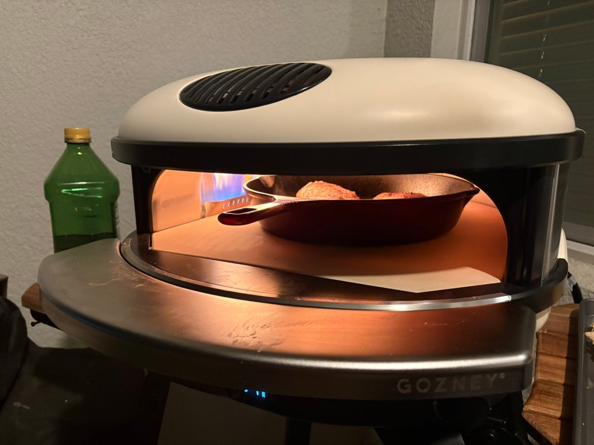 A skillet of chicken cooking in the Gozney Arc XL