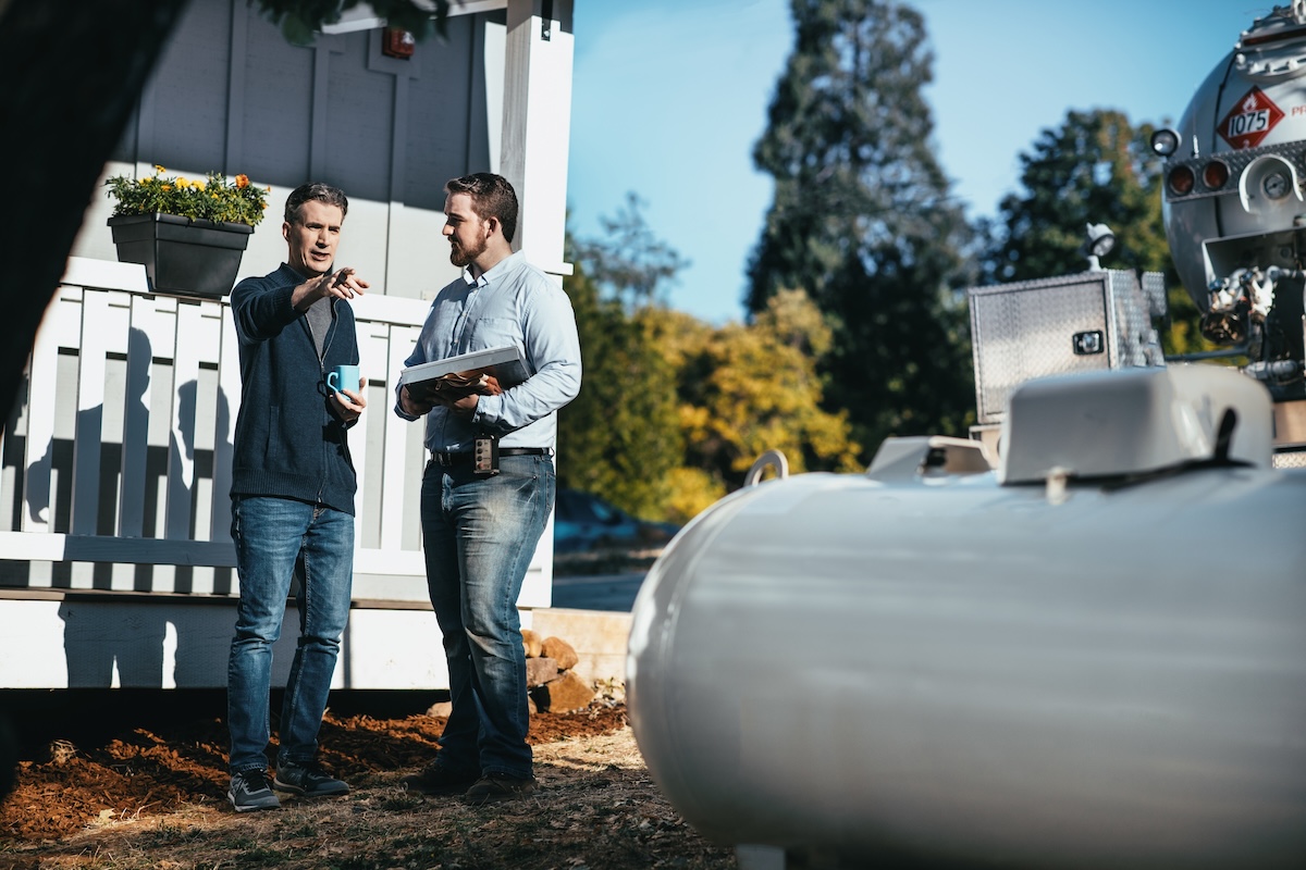 A homeowner speaking with a propane pro about how to set up a home with propane power.