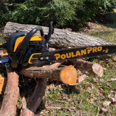The Poulan Pro PR5020 Gas chainsaw on a pile of wood during testing