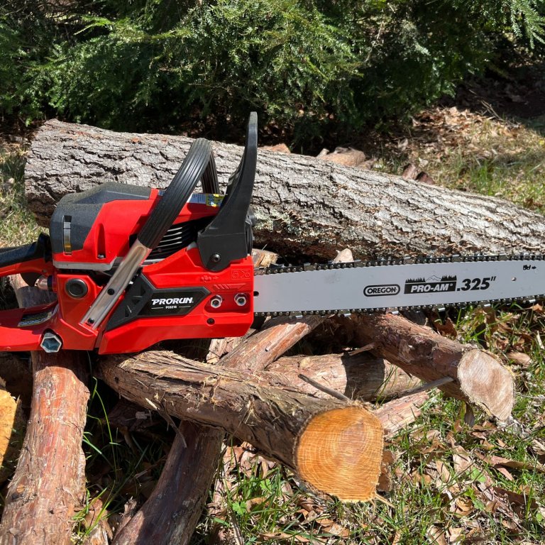The Prorun 18-Inch PCS218 45 cc Chainsaw on a pile of cut wood during testing