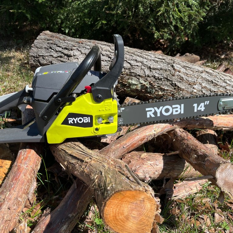The Ryobi 14-Inch 37cc 2-Cycle Gas Chainsaw on a pile of wood during testing