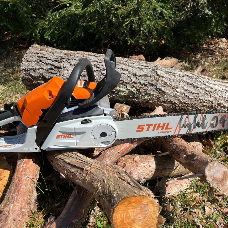 Stihl MS 182 C-BE Gas Chainsaw on a pile of wood during testing