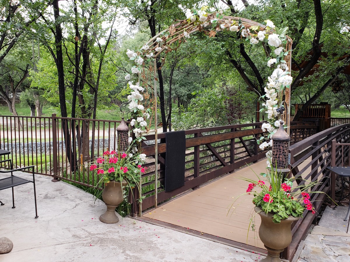 A bridge with two flower pots flanking the sides, showing when not to use the rule of threes in gardening.
