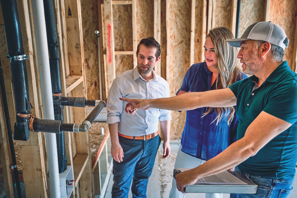 Couple discusses propane connections in their new construction home with the builder.
