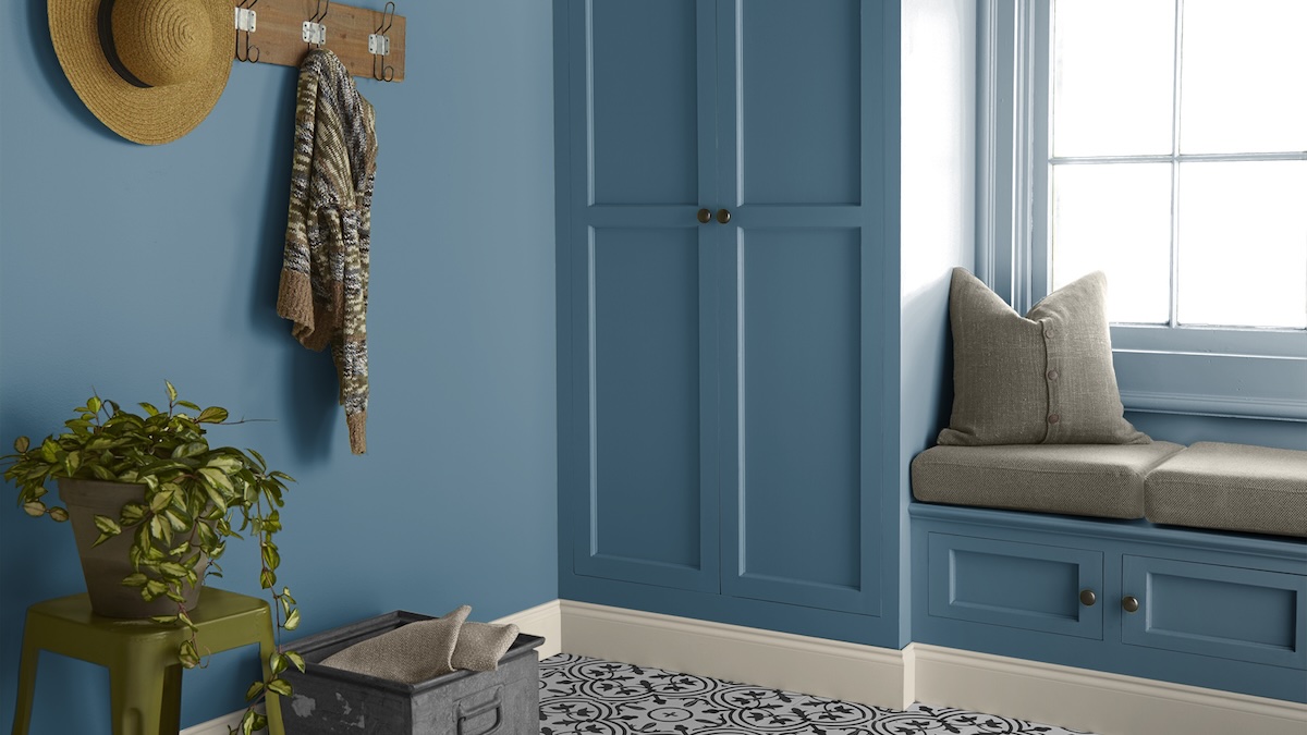 A hallway with built-in cabinets painted in Behr's "Superior Blue" paint. 