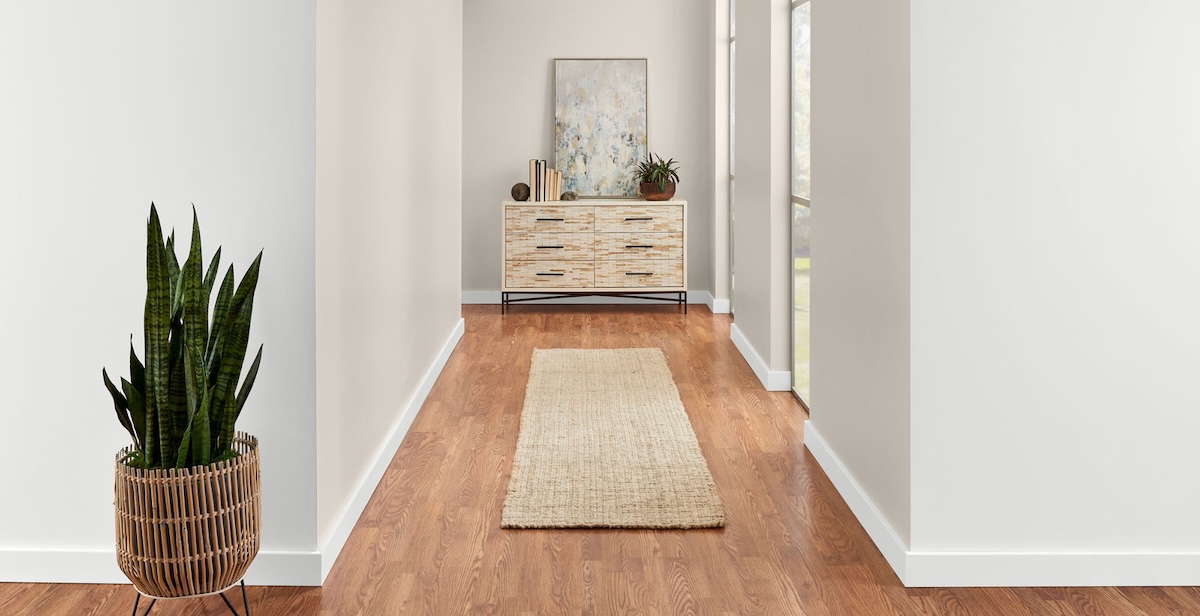A long hallways painted in a soft, grey-beige color. 