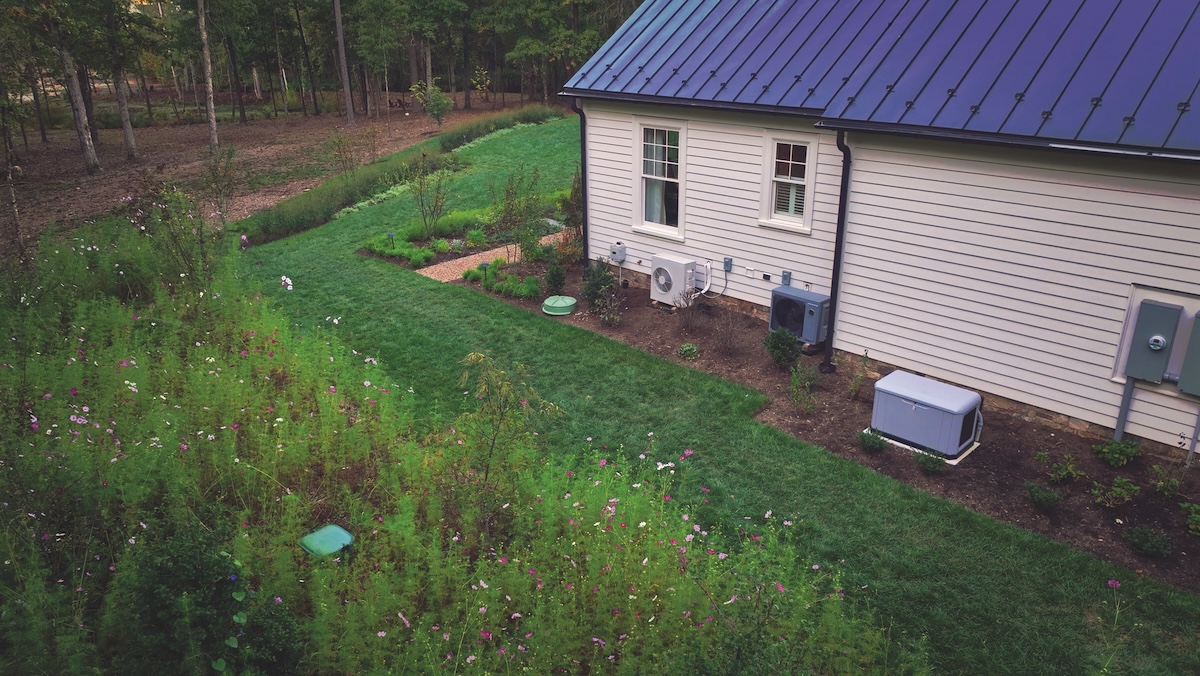 A home exterior showing propane tanks and heat pump and generator
