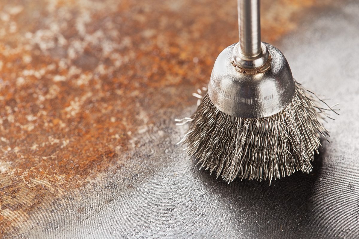 Steel brush for drill cleaning off old metal sheet with rust