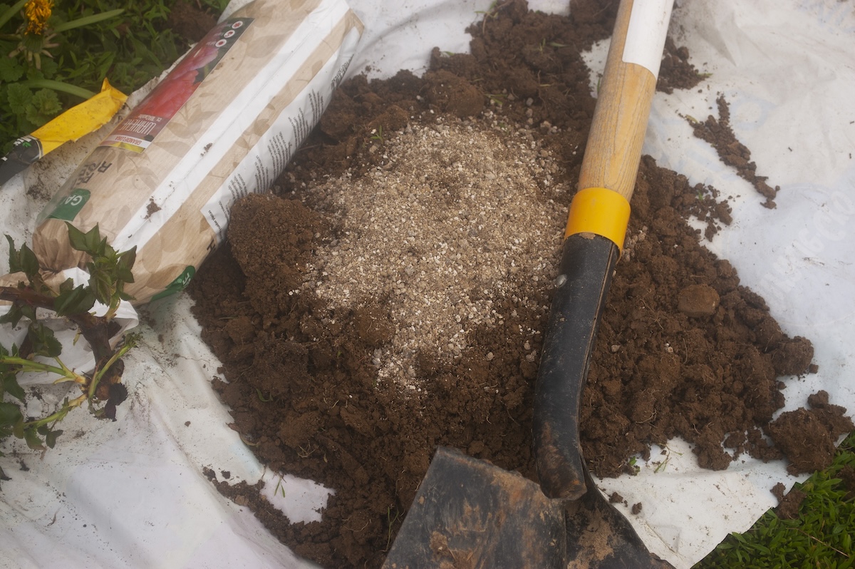 An open soil bag recycled into a garden tarp.