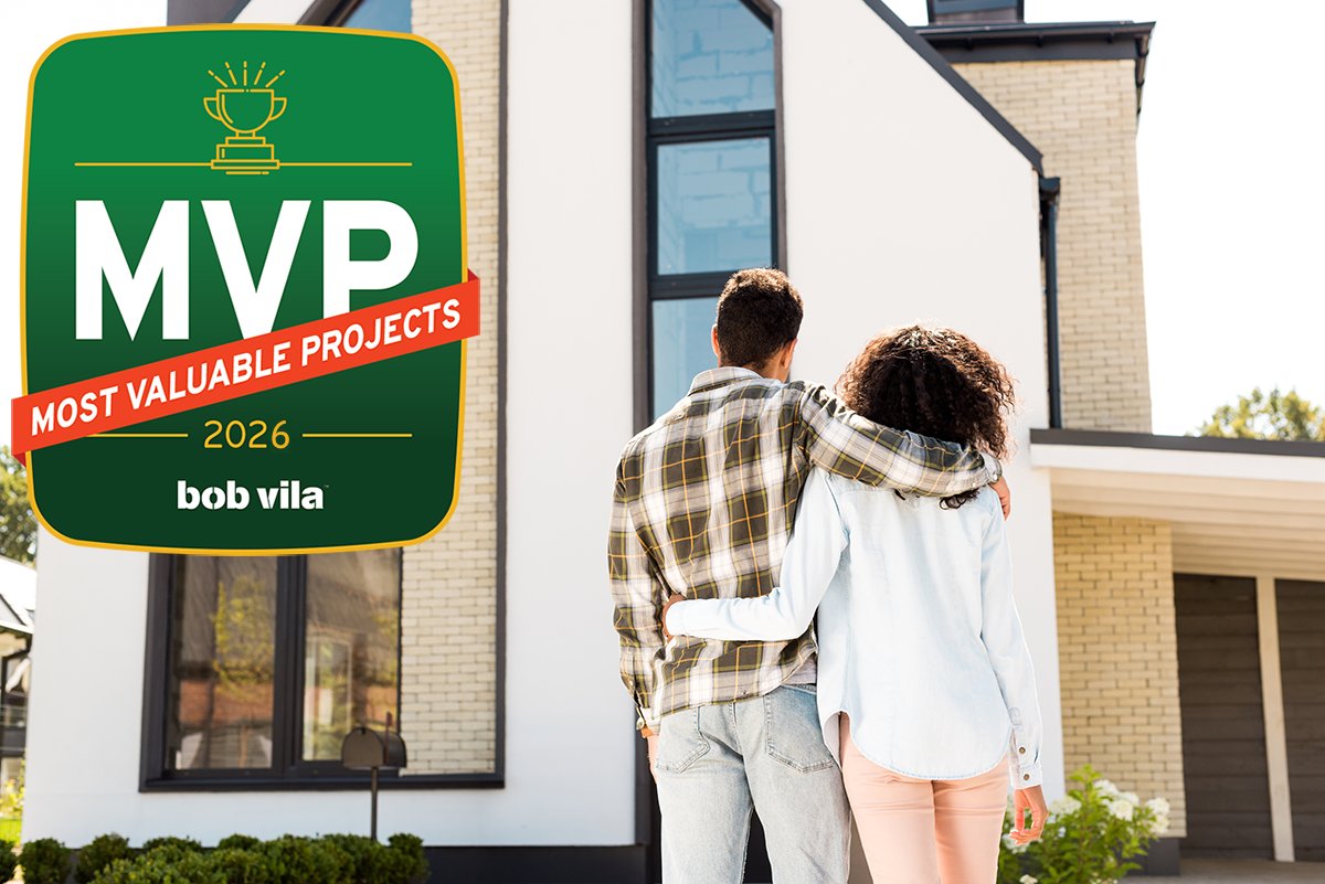 A couple looking at the front of their house for curb appeal.