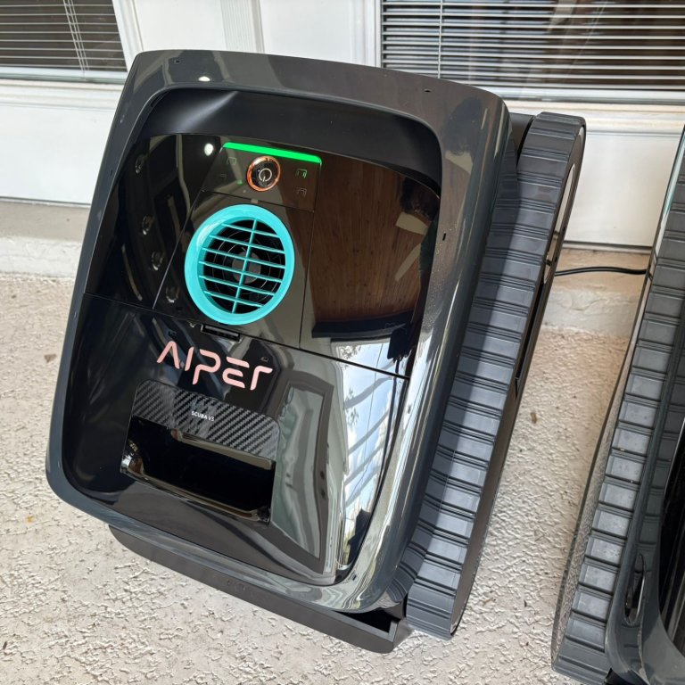 The Aiper Scuba V3 in a screen-in pool area before testing