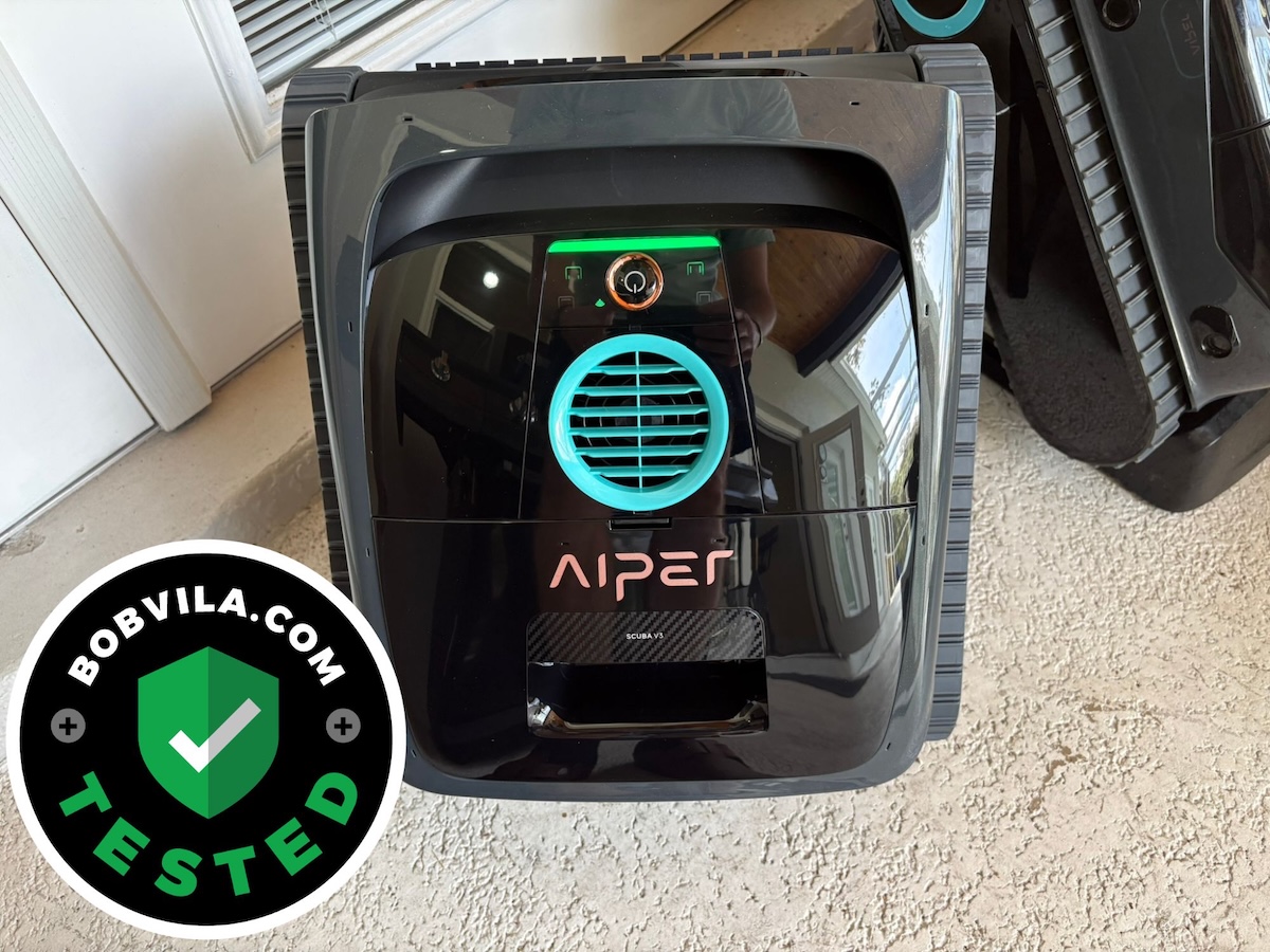 The Aiper Scuba V3 robotic pool cleaner in a pool area before testing