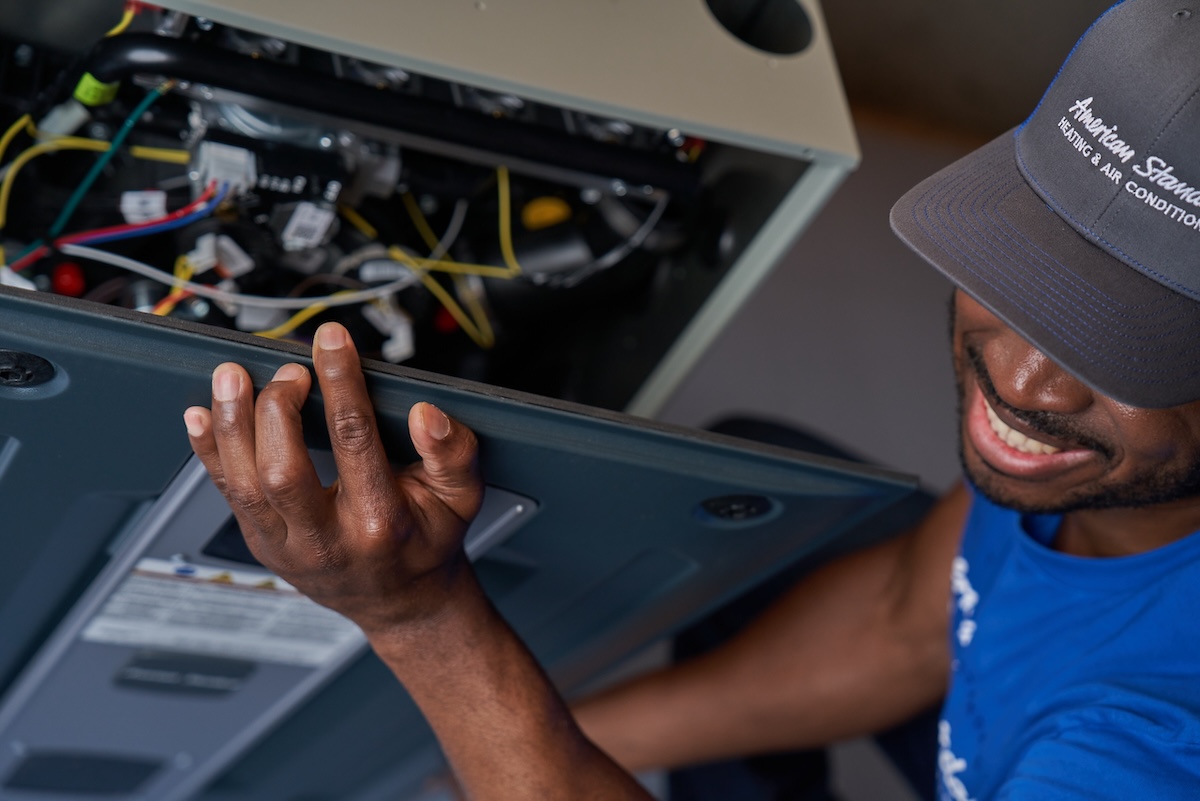 An American Standard technician opening up a unit before installation.