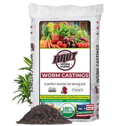 A bag of Brut Organic Worm Castings for Plants on a white background next to a small pile of the fertilizer and a thriving plant
