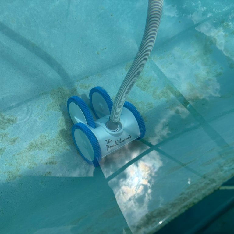 the Hayward ThePoolCleaner 4-Wheel Suction Pool Cleaner cleaning the bottom of a pool during testing