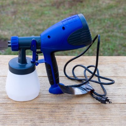 The HomeRight Quick Finish HVLP Paint Sprayer on an outdoor table during testing