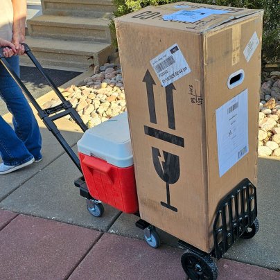 The Kedsum 3-in-1 Dolly Hand Truck with a cooler and large box on it during testing