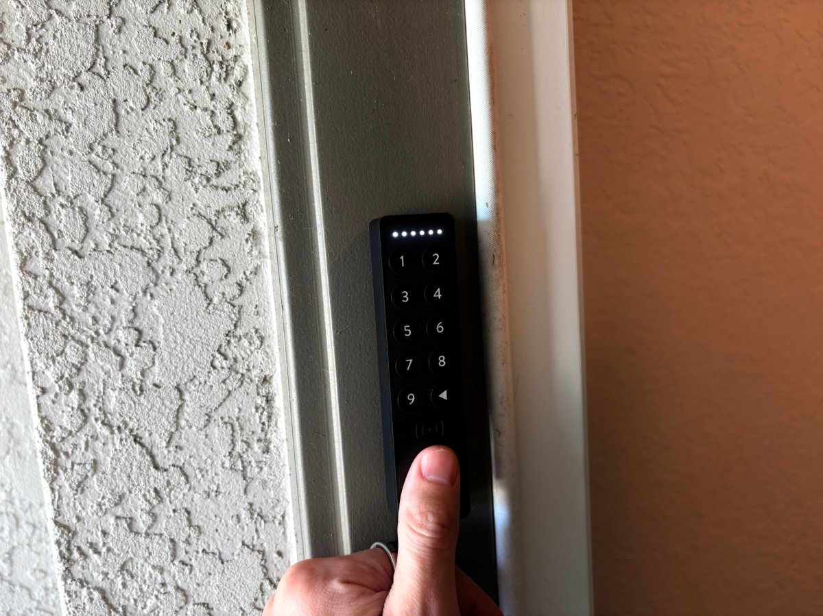 Product tester using their thumb to unlock the Nuki Smart Lock keypad
