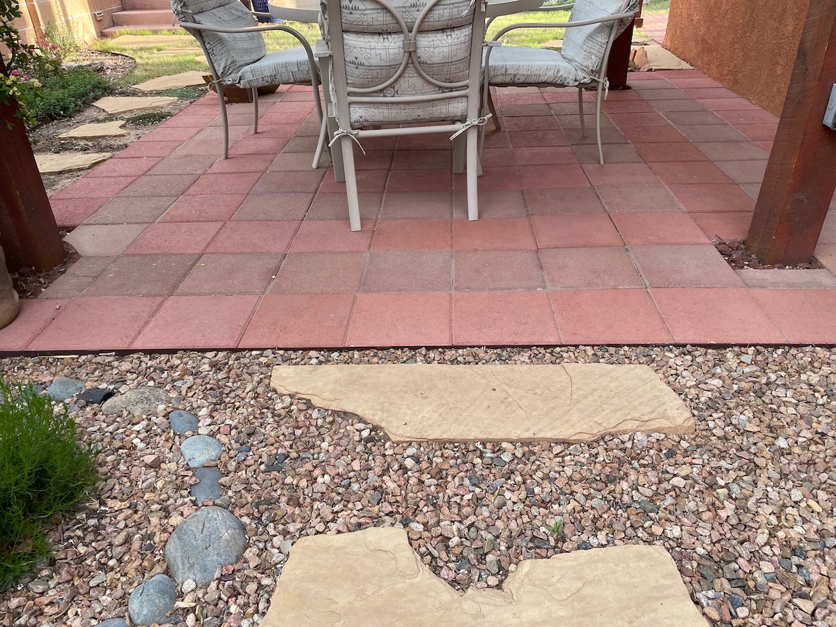 Final after photo showing writer's DIY patio project with mixed pavers.