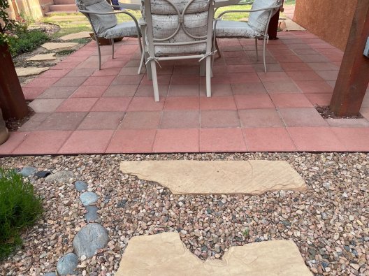 Final after photo showing writer's DIY patio project with mixed pavers.