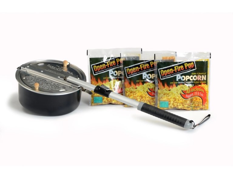 The Open-Fire Pop 4-Piece Outdoor Popcorn Popper with packages of popcorn on a white background