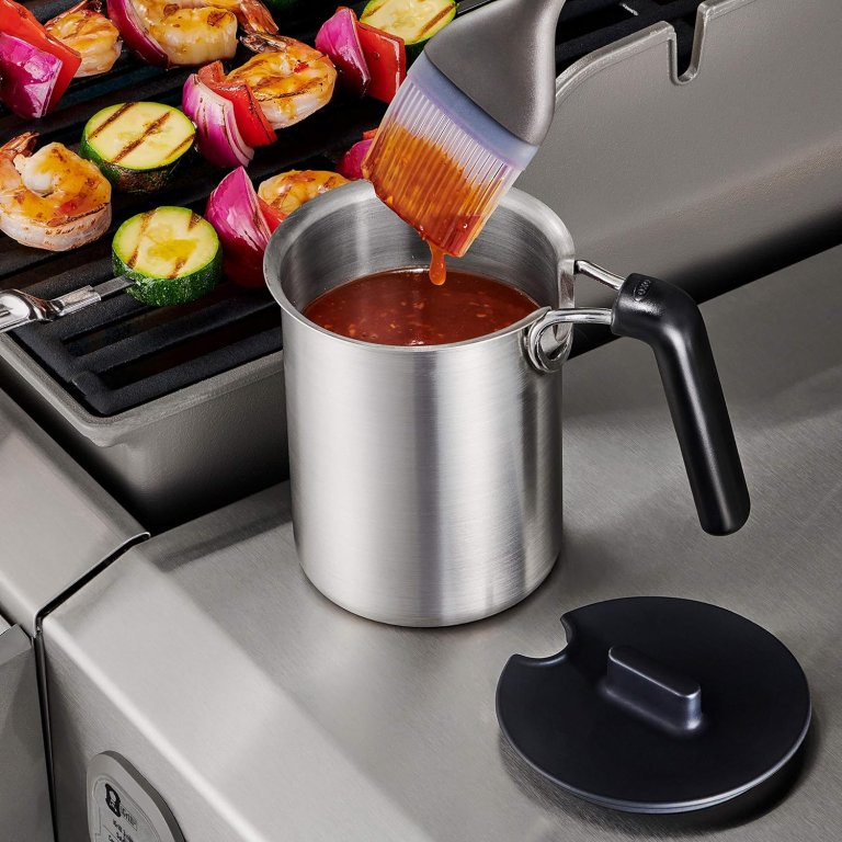 The Oxo Grilling Basting Pot full of sauce and on a brush for application to grilled vegetables