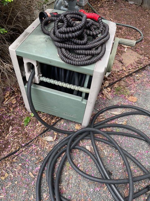 Pocket Hose 75-Foot Copper Head Expandable Garden Hose next to a rubber hose