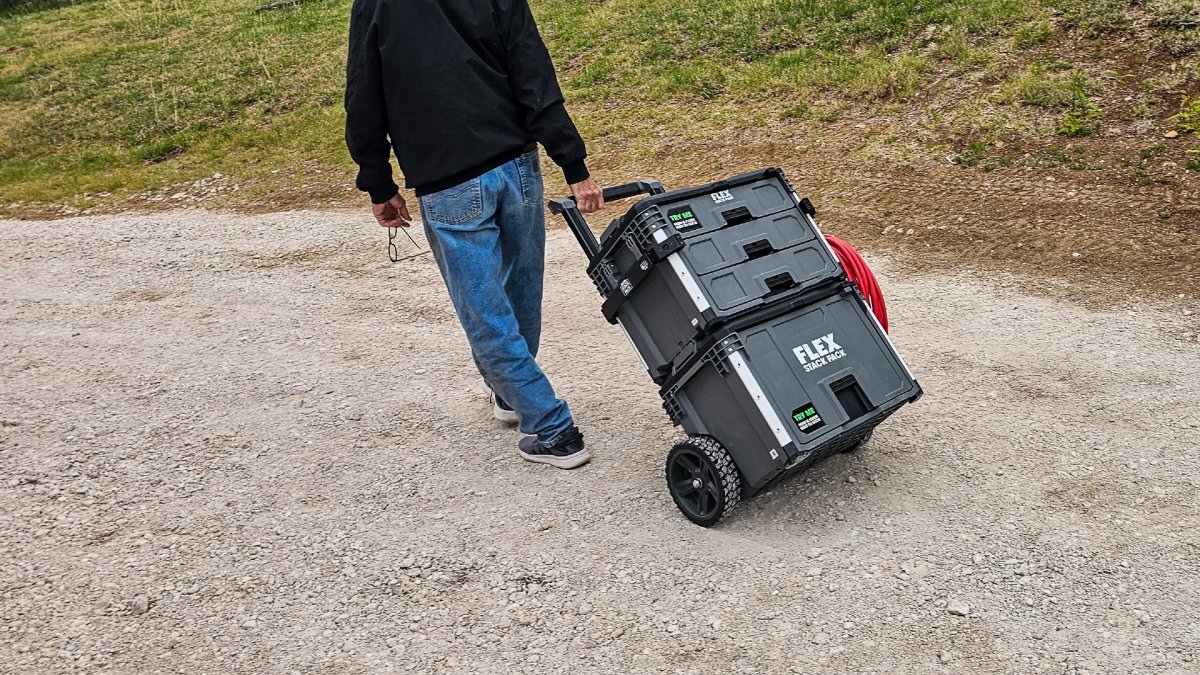 A product tester rolling a stack of Flex tool boxes during testing